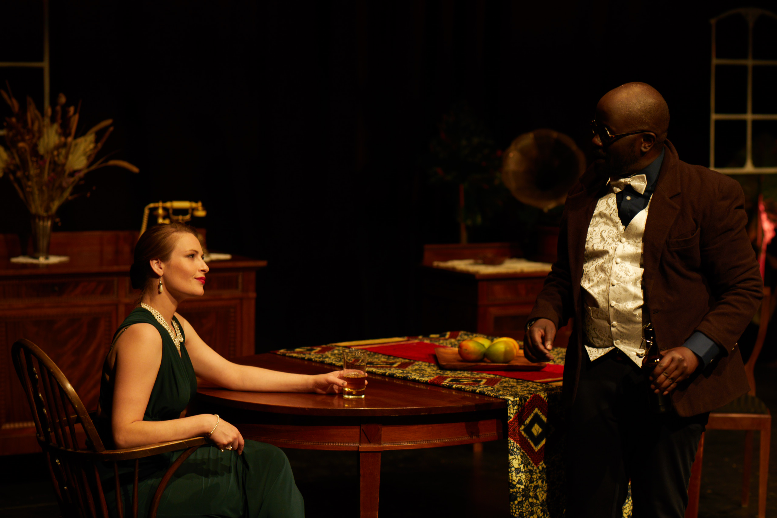 Alice de Janzé seated with Jean in a ritual of drink and control.